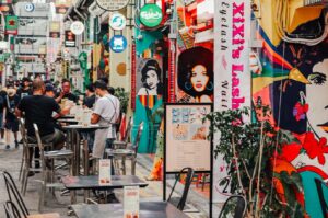 bustling street in Singapore filled with people and various shops, highlighting affordable food options.