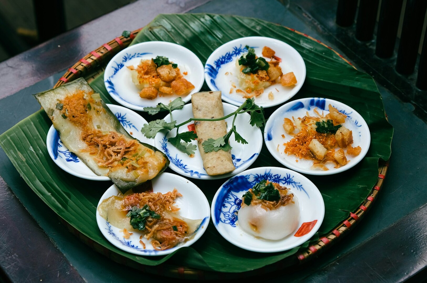 A selection of popular hawker dishes arranged on a banana leaf, highlighting the vibrant colors and textures of the food.