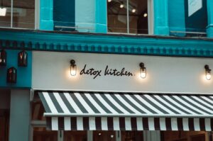 A restaurant featuring a black and white striped awning, highlighted in a guide to the best Michelin star dining options.