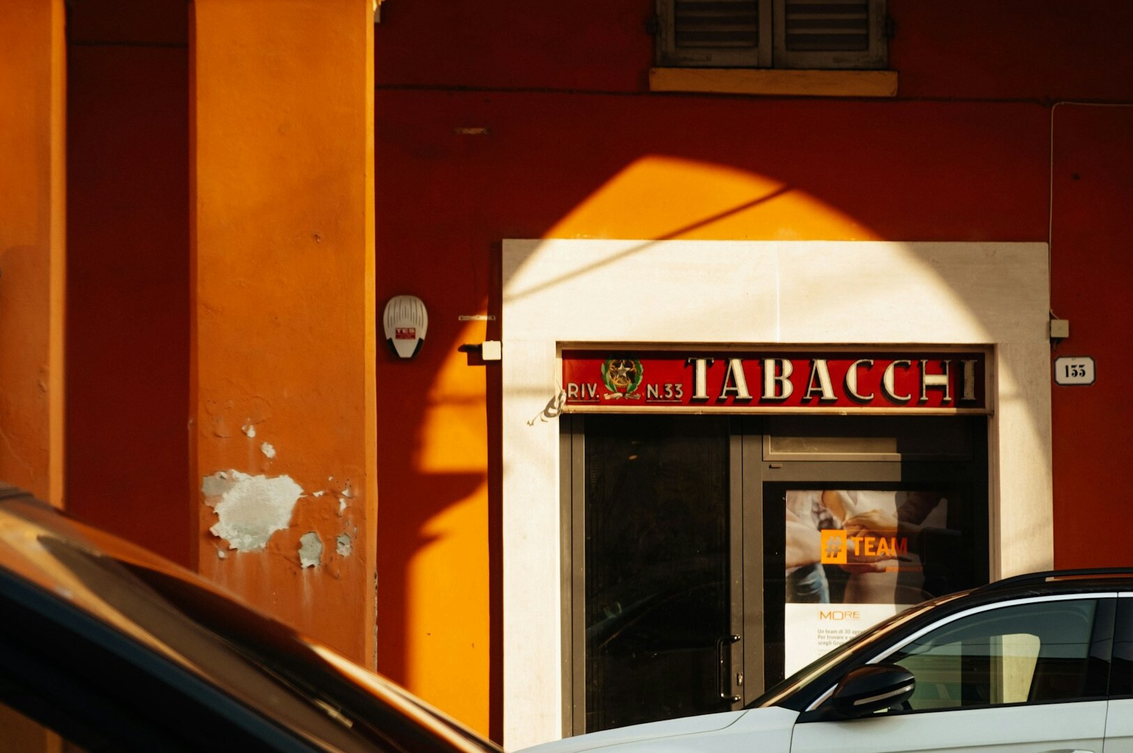 A car parked outside a Michelin star restaurant in Modena, Italy, known for its fine dining experience.