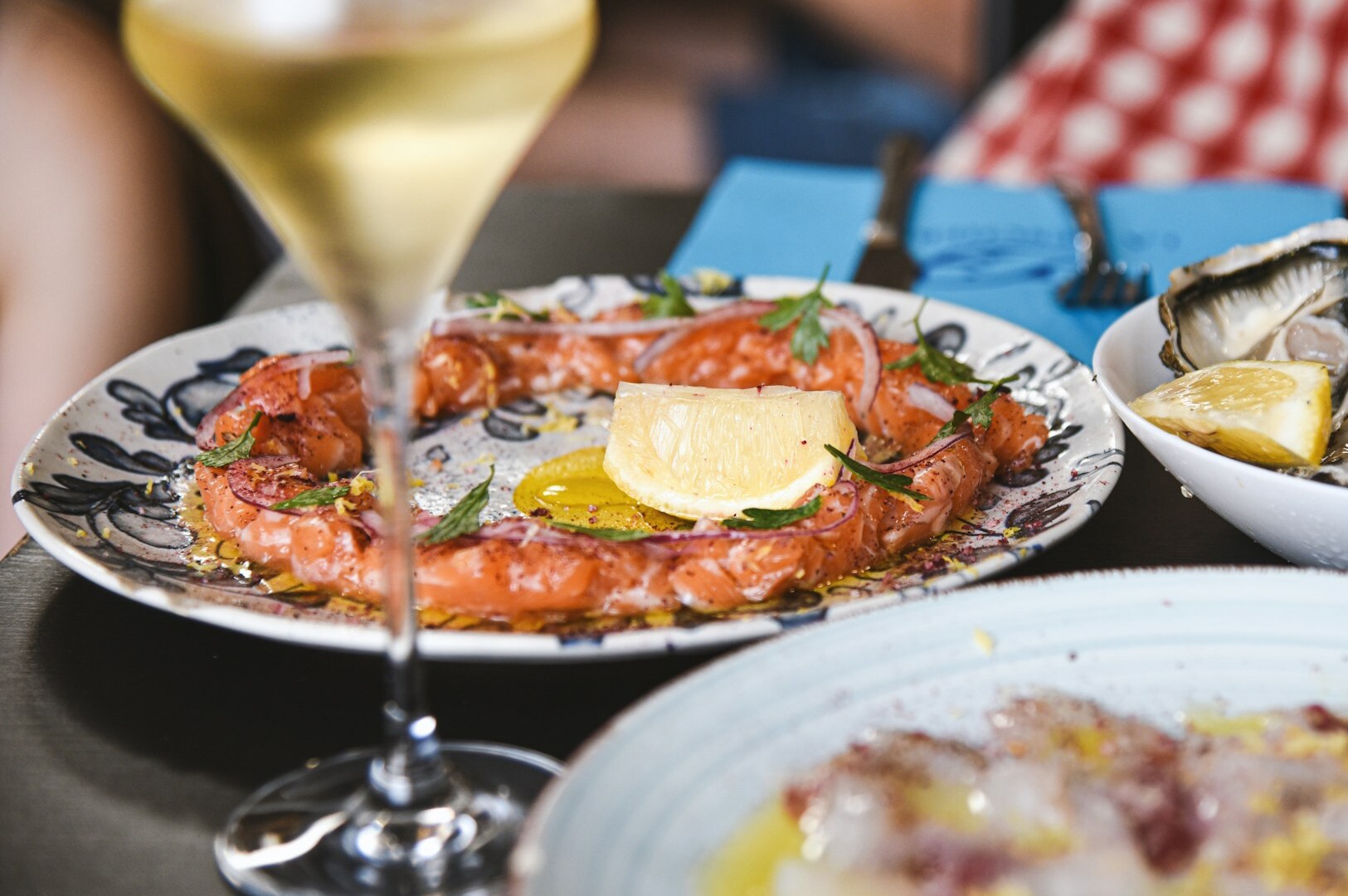A plate of seafood with a glass of white wine, highlighting the complementary pairing of flavors of fish and wine.