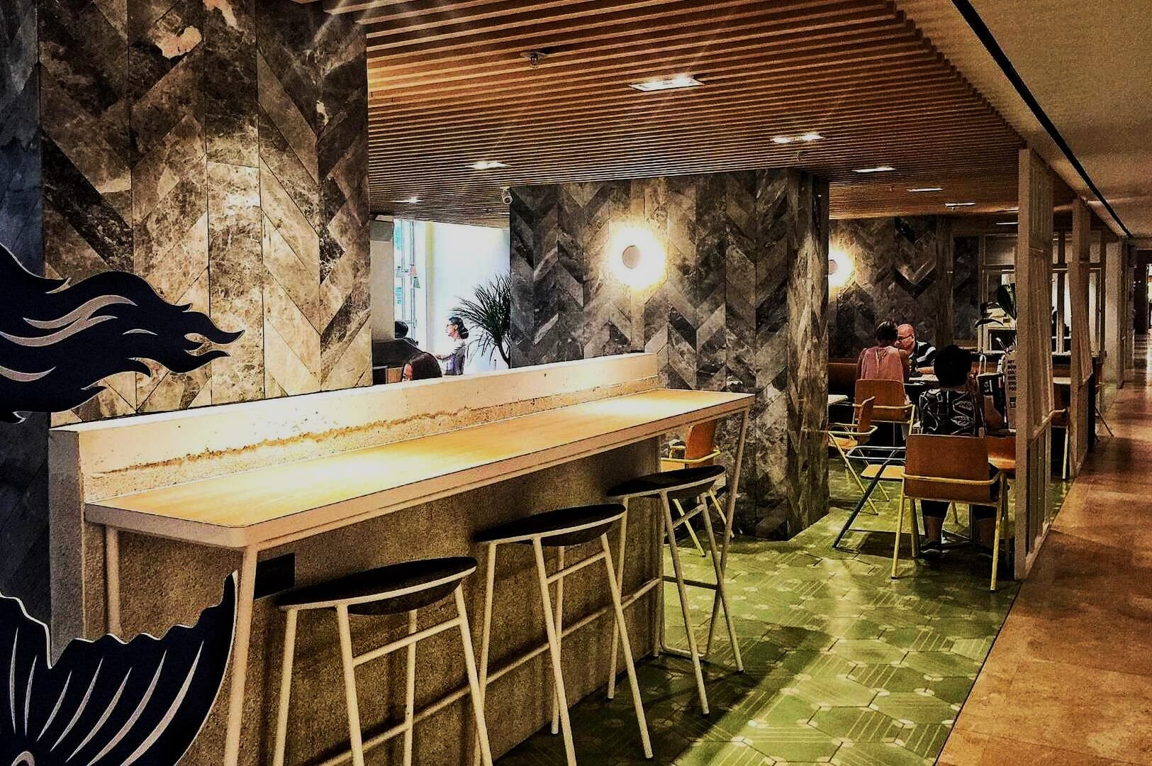 A restaurant in Singapore offers a stylish dining experience near City Hall MRT Station.