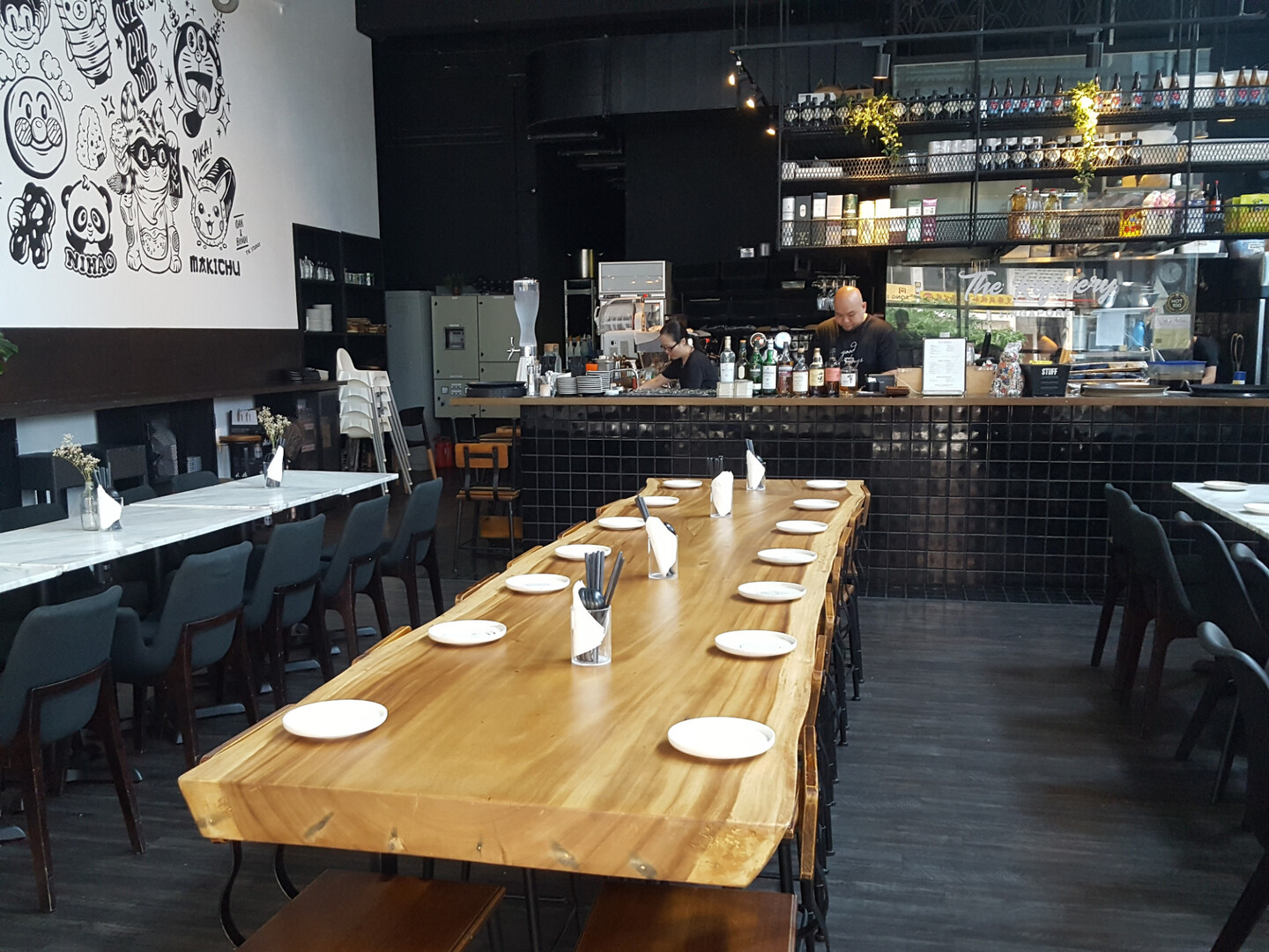 A cafe and restaurant in Lavender MRT, Singapore, featuring tables and chairs arranged in the center of the room.