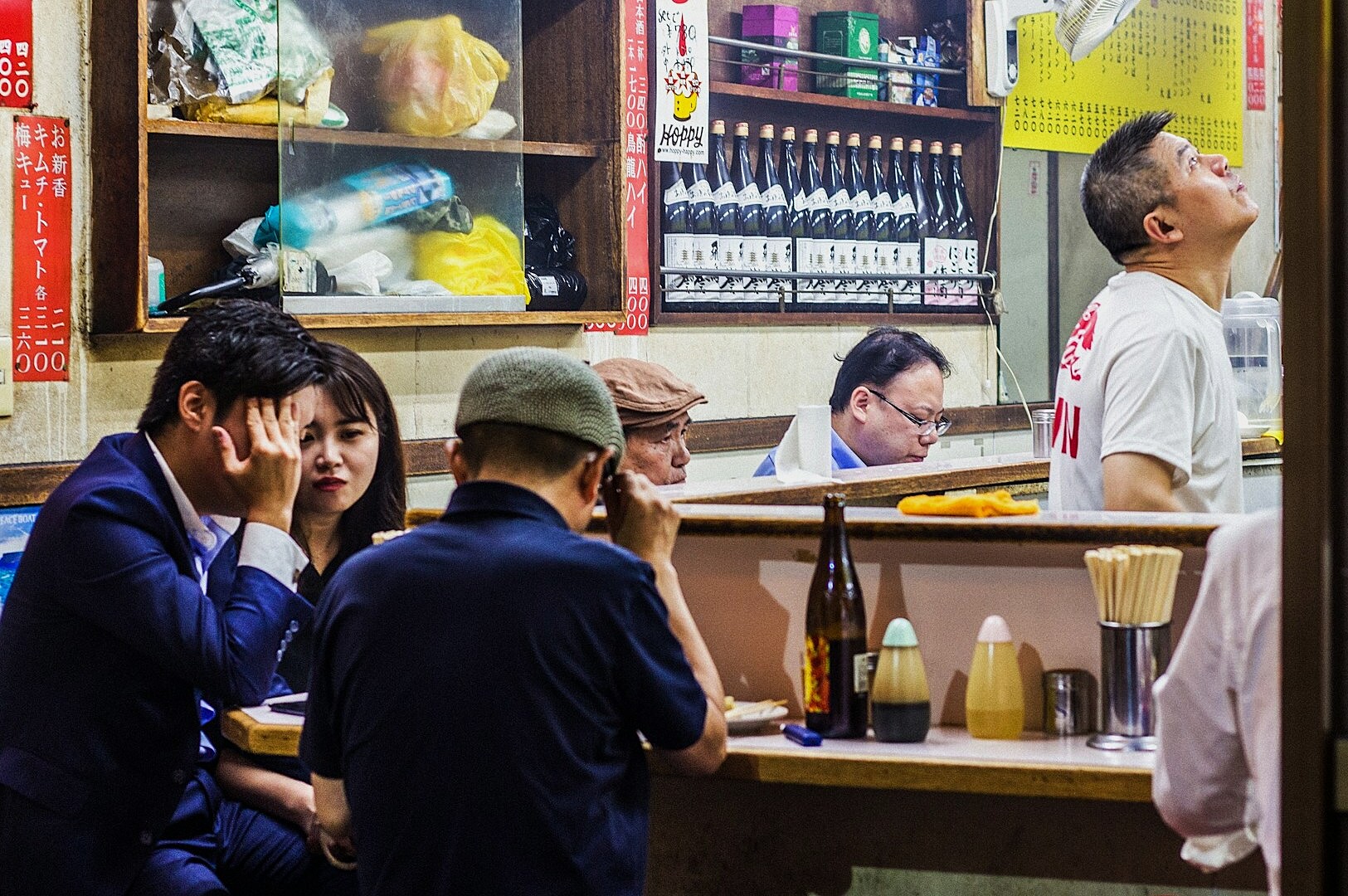 A man dressed in a blue suit, embodying the essence of Nomikai in Japanese culture.