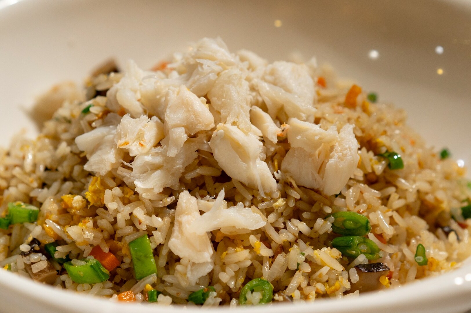 A serving of rice accompanied by meat and mixed vegetables, showcasing Singapore's public transport food culture.