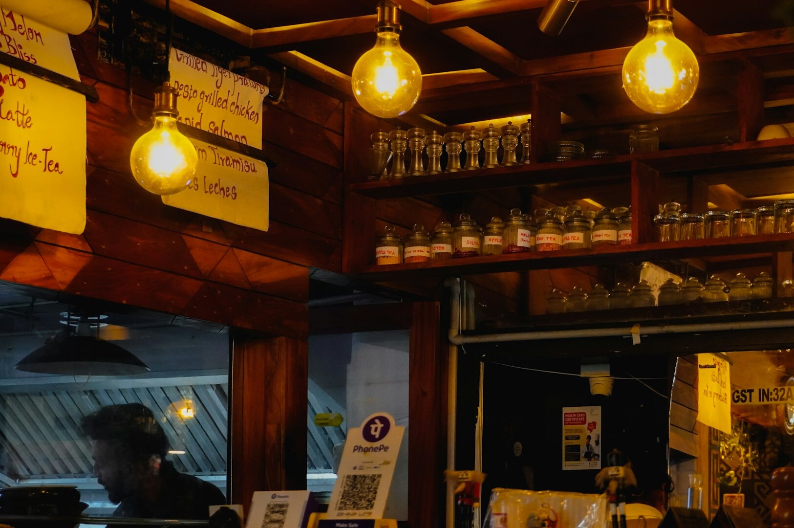 Interior of a restaurant with a bar and ambient lighting, highlighted in a list of must-visit cafes in Singapore.