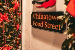 Vibrant food street sign in Singapore's Chinatown, featuring a variety of tasty and budget-friendly dishes.
