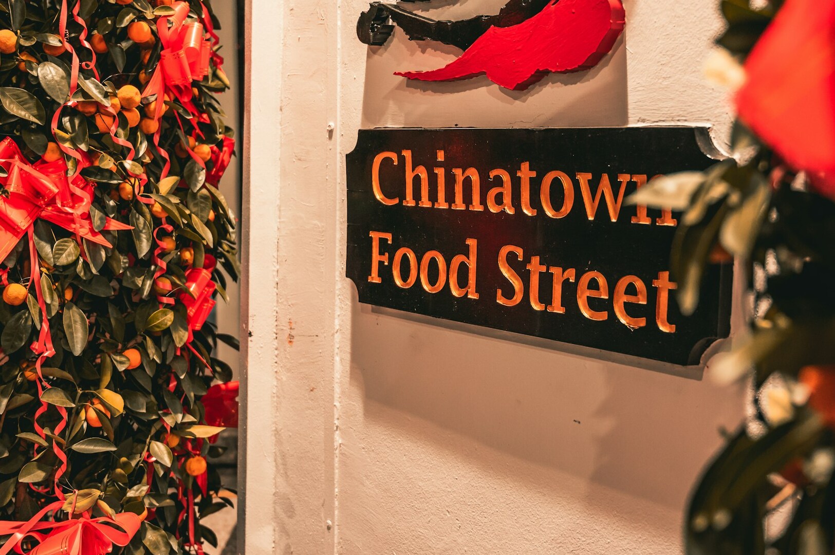 Vibrant food street sign in Singapore's Chinatown, featuring a variety of tasty and budget-friendly dishes.