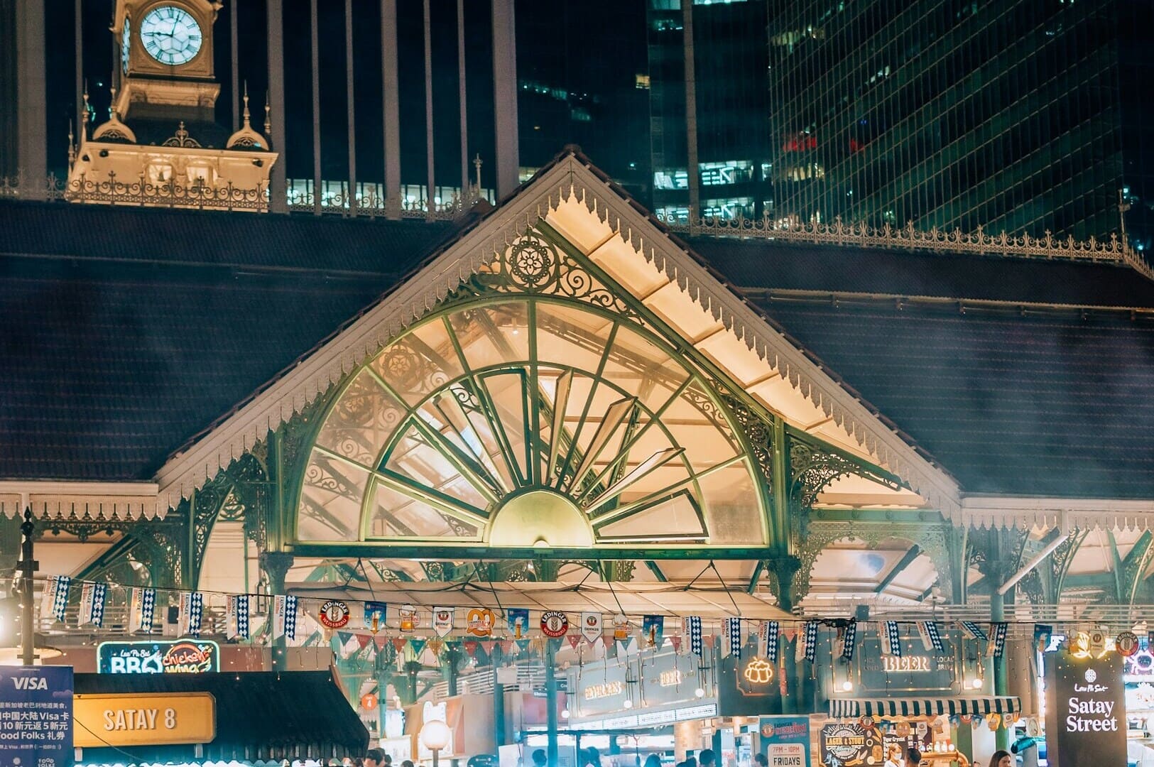 A large building surrounded by a bustling crowd at Singapore Hawkers.