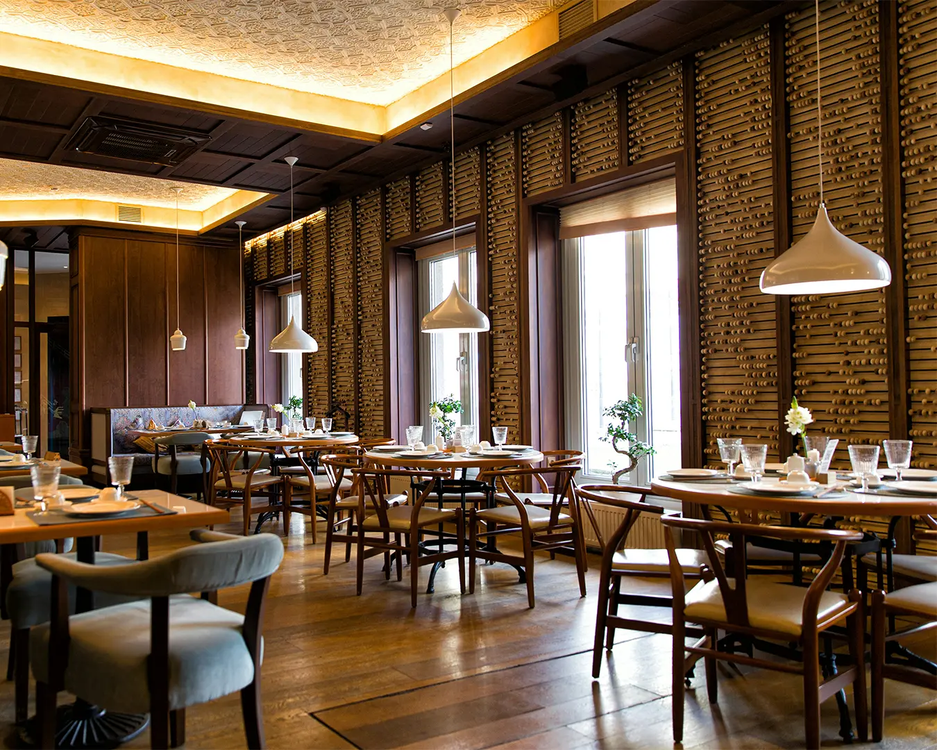 An elegant restaurant interior in Singapore featuring warm ambient lighting, refined table settings, and modern décor that creates a sophisticated dining atmosphere ideal for enjoying contemporary Asian cuisine.