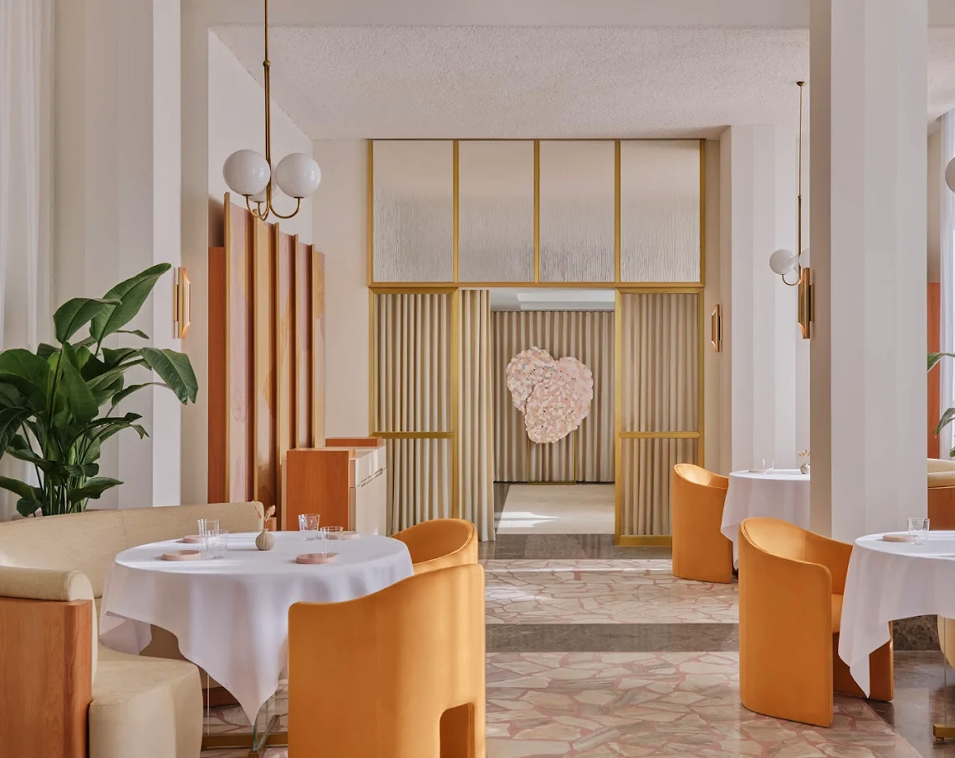 Elegant fine-dining interior of Odette Singapore, featuring soft ambient lighting, modern French décor, and neatly set tables that create an intimate and refined dining atmosphere.