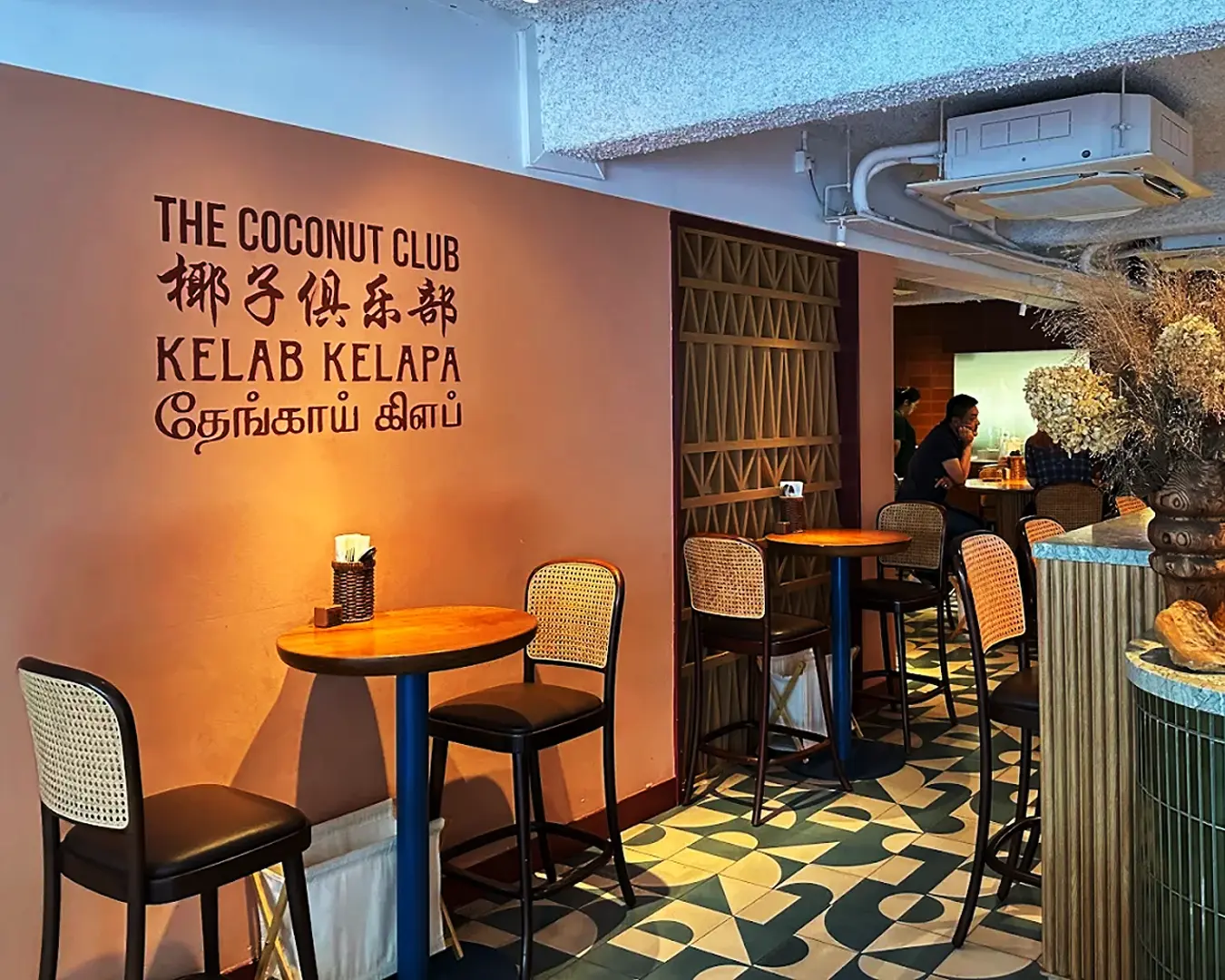 The warm and inviting interior of Coconut Club café, featuring modern décor, wooden furnishings, and a relaxed dining atmosphere.