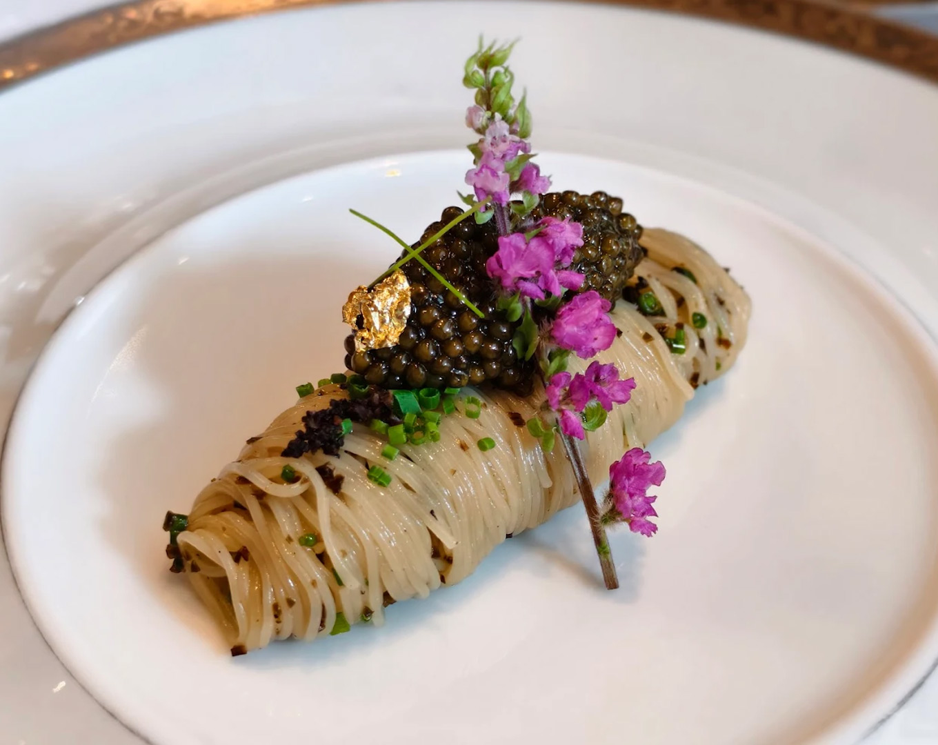 A refined plate of spaghetti inspired by classic French technique, beautifully arranged with delicate garnishes, reflecting timeless elegance and culinary craftsmanship.