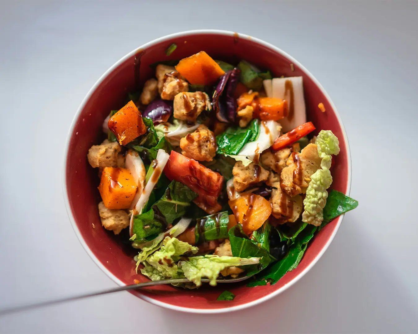 A humble bowl of budget-friendly vegetarian meal, including simple yet nourishing ingredients like tofu, and vegetables.