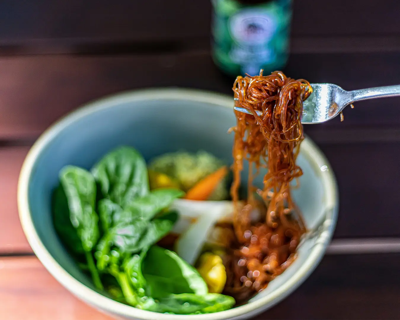 A light and colourful bowl of glass noodles mixed with fresh vegetables, showcasing a simple and wholesome dish often found in Asian cuisine.
