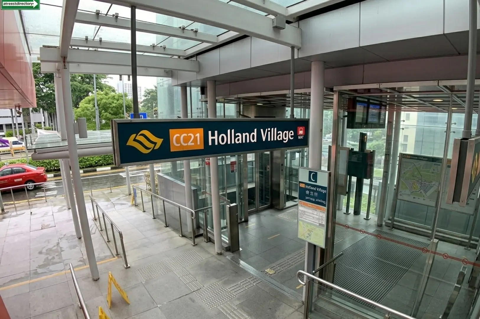 Holland Village MRT station entrance with CC21 station code sign and glass elevator structure