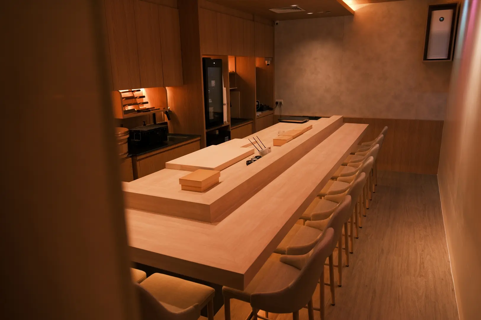 Interior of Sushi Masa by Ki-setsu featuring a long wooden omakase counter and warm ambient lighting