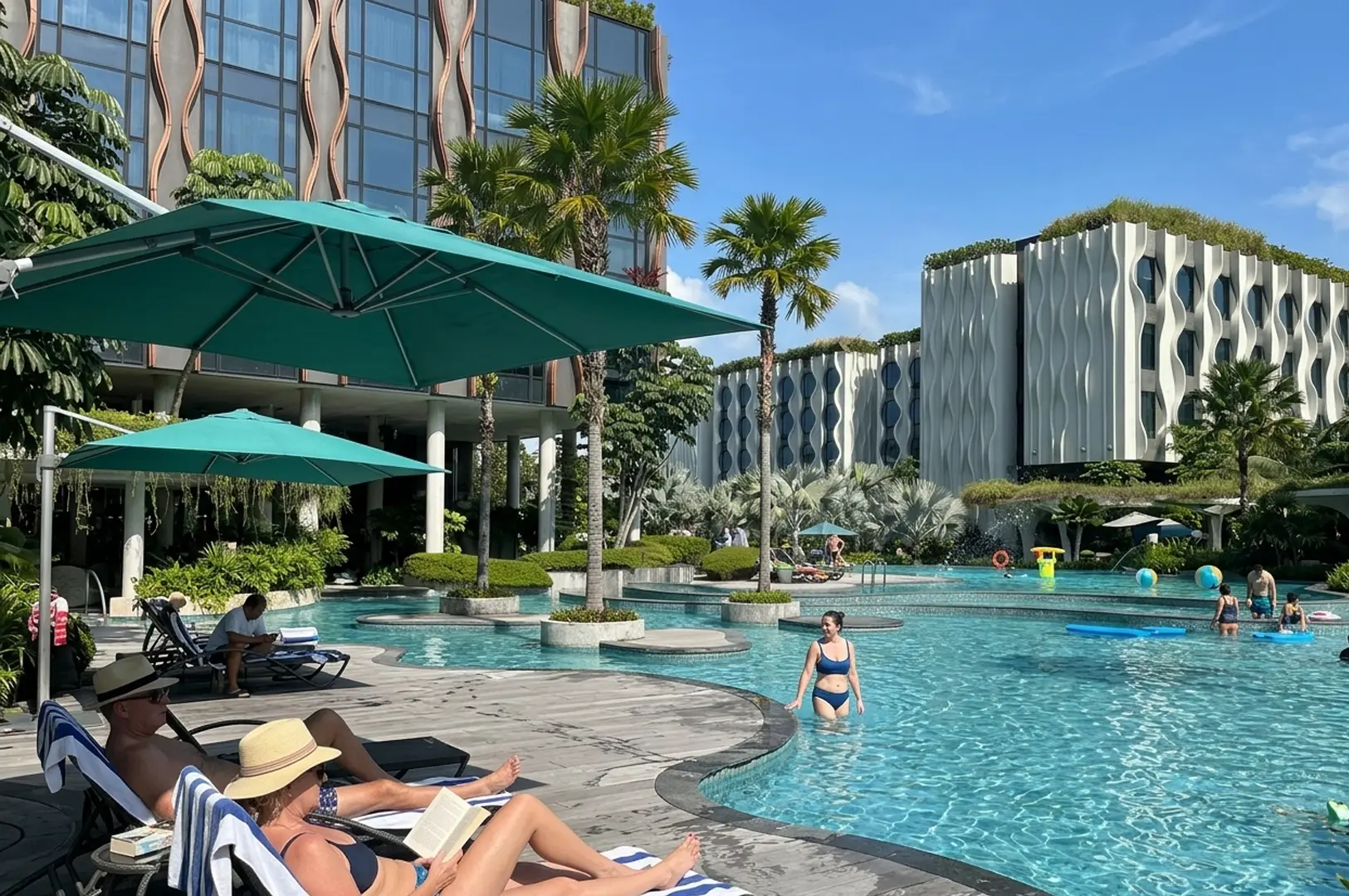 Resort pool area with guests swimming and lounging, modern wavy hotel buildings and palm trees