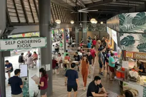 Modern hawker center with self-ordering kiosk and diners