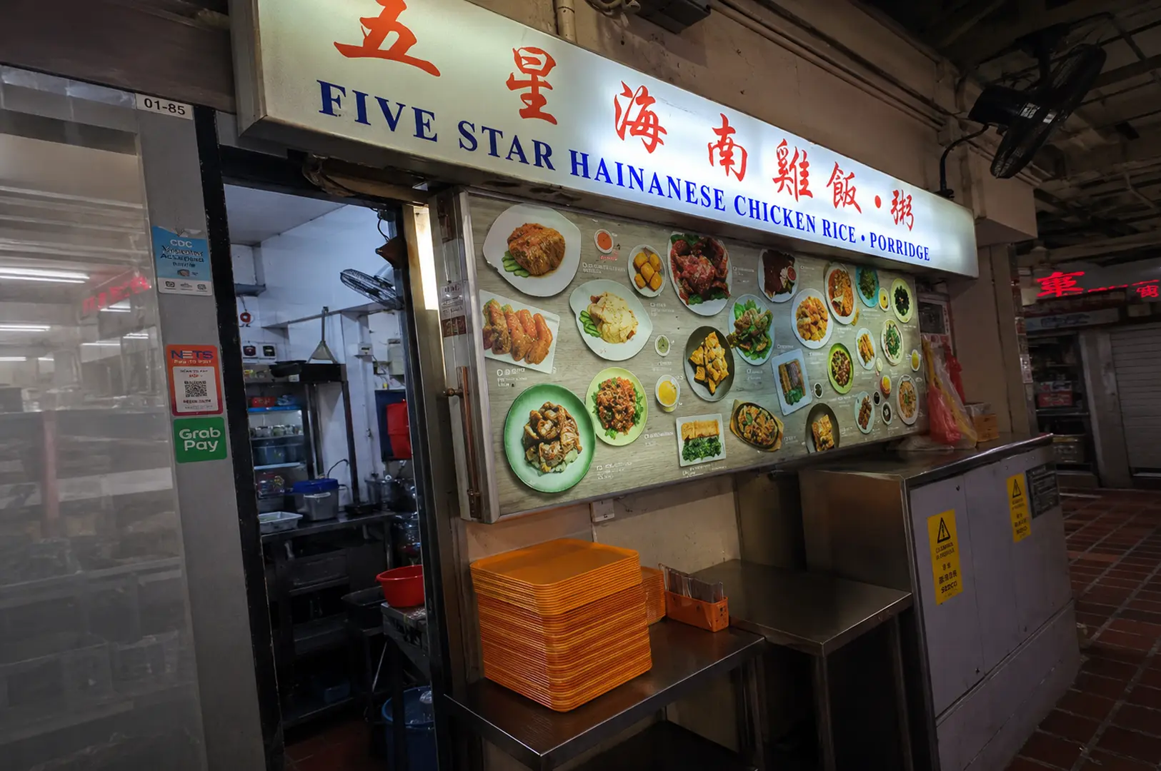 Five Star Hainanese Chicken Rice hawker stall storefront with menu board and stacked trays