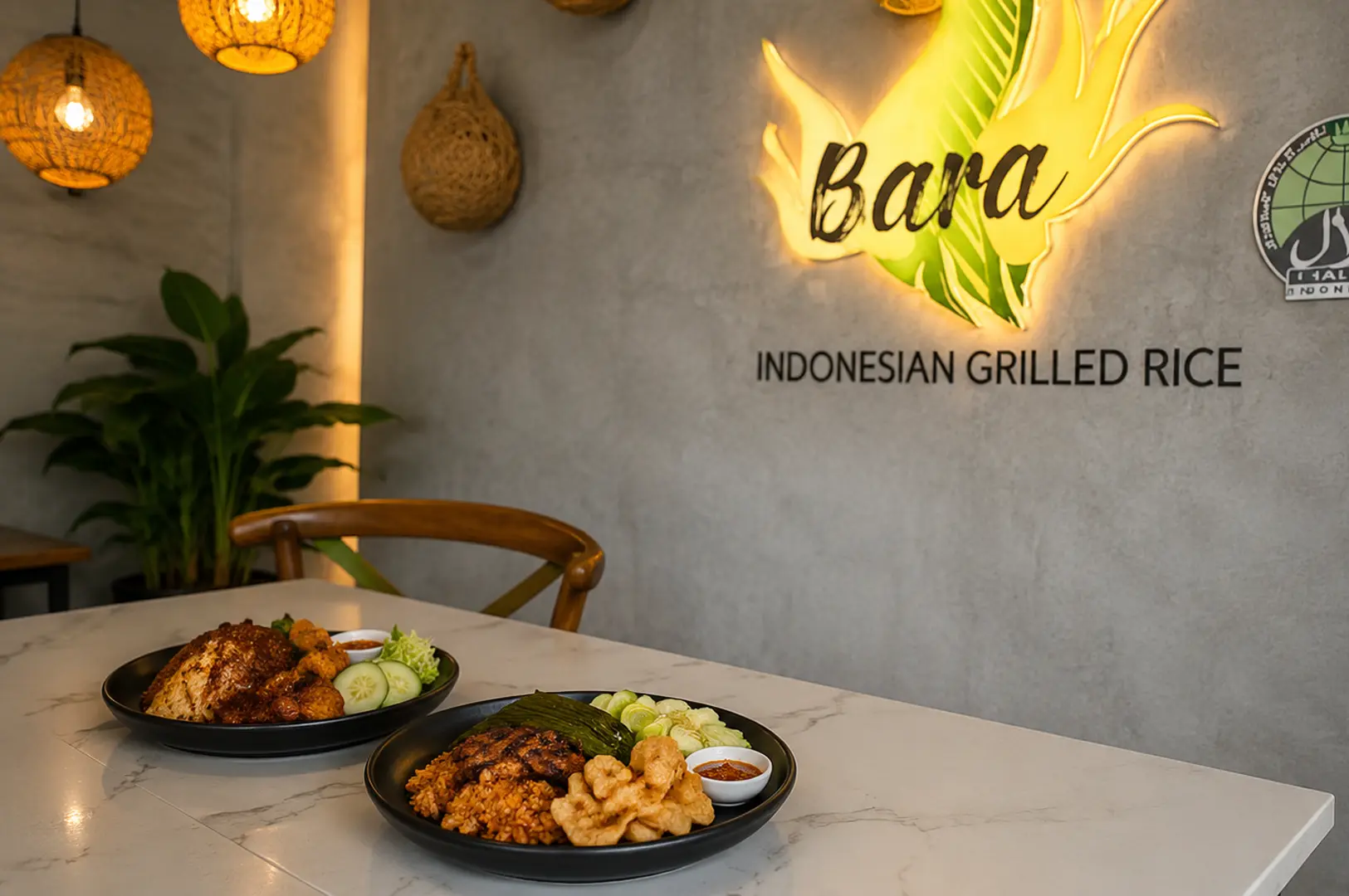 Two plates of Indonesian grilled rice (nasi bakar) with side dishes served at Bara Indonesian Grilled Rice restaurant with illuminated signage