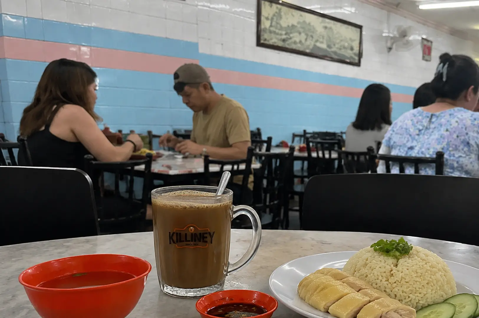 Killiney coffee mug with Hainanese chicken rice plate at casual kopitiam restaurant