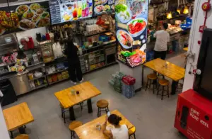 Tanjong Pagar food centre interior with dining tables, food stalls, and menu displays.