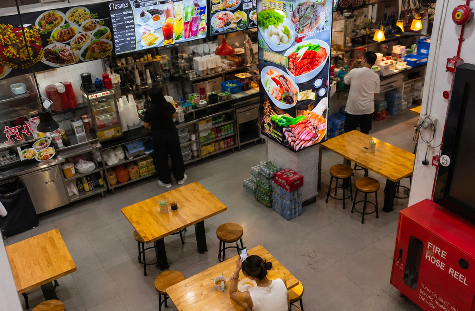 Tanjong Pagar food centre interior with dining tables, food stalls, and menu displays.