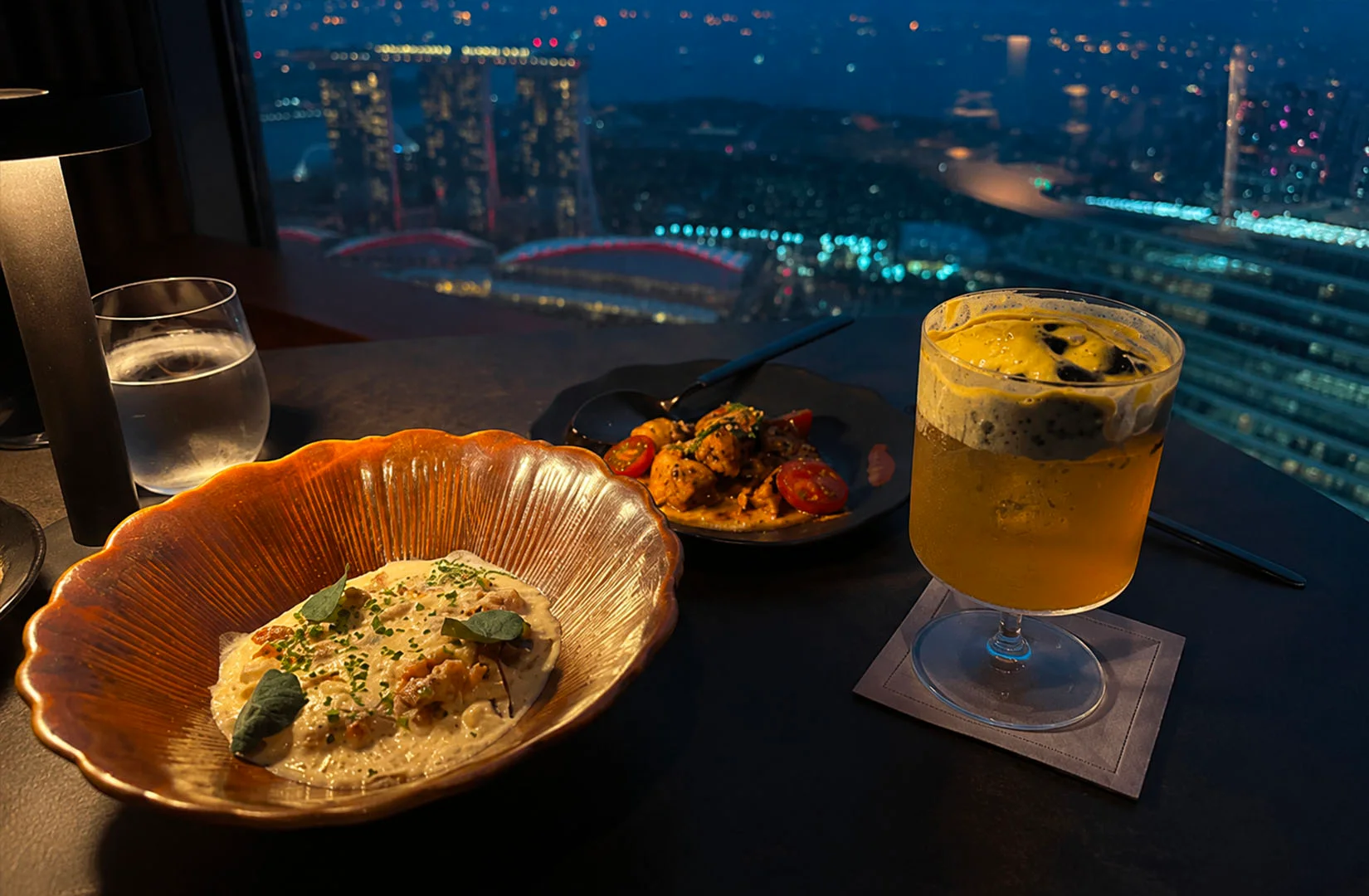 Restaurant dining experience with city skyline highlighting the best restaurants in Raffles Place Singapore.