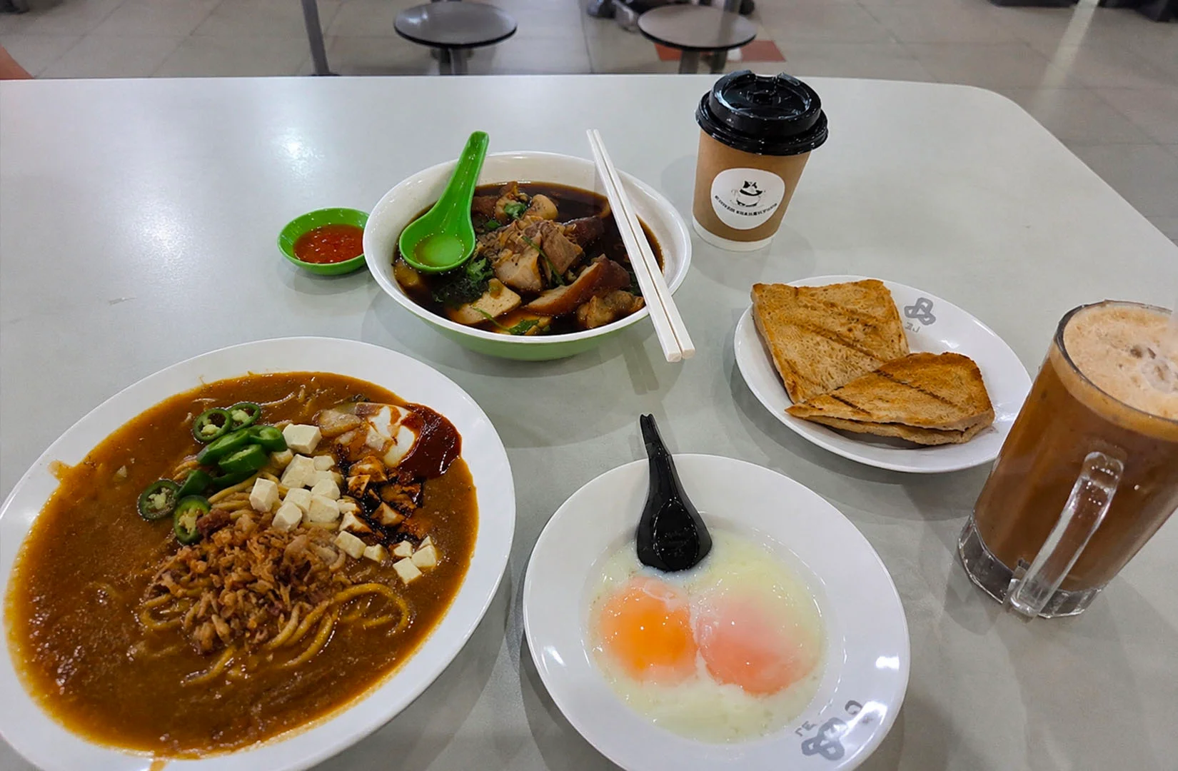 Tanjong Pagar hawker food spread with noodles, soup dish, kaya toast, soft-boiled eggs, and kopi.