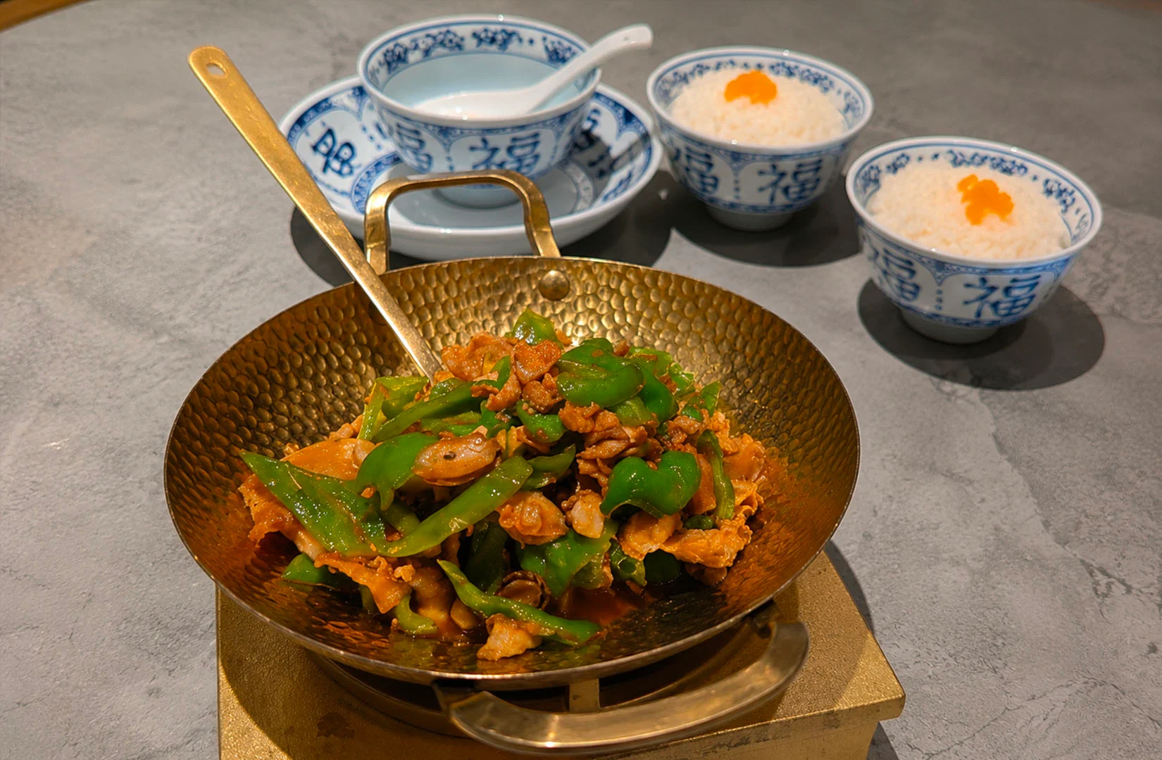 Signature stir-fried dish with rice and soup at Nong Geng Ji Singapore restaurant.
