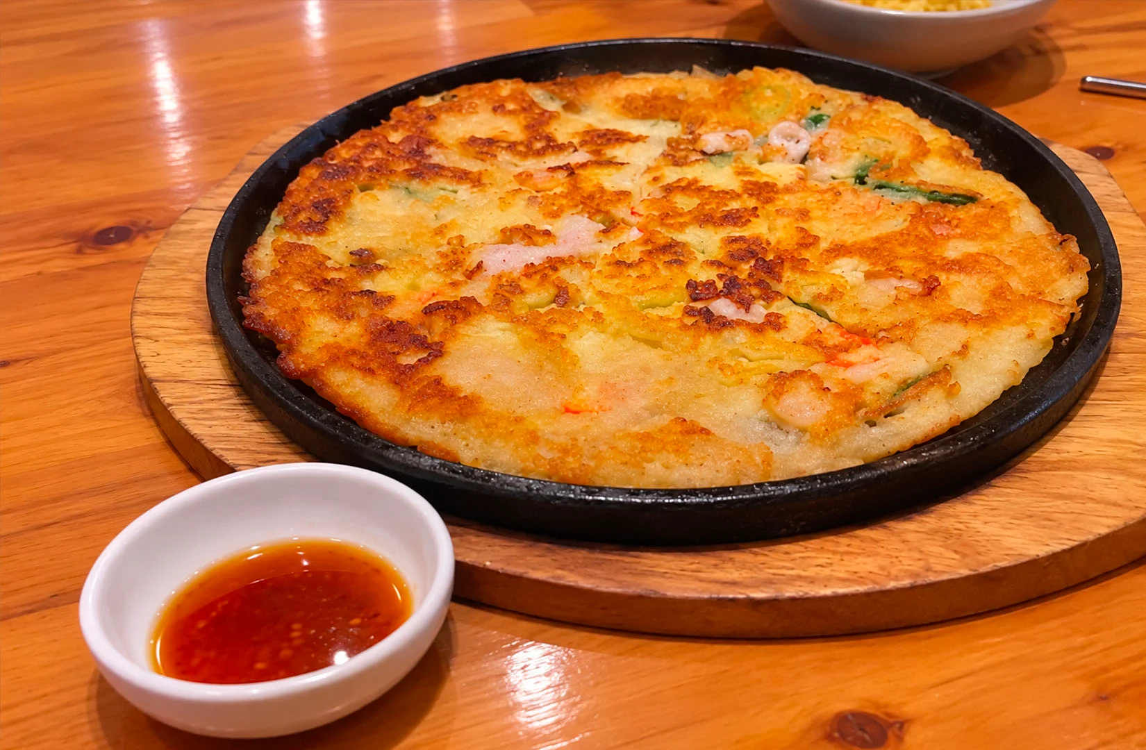 Crispy Korean seafood pancake served with dipping sauce at Joah Korean Restaurant Singapore.