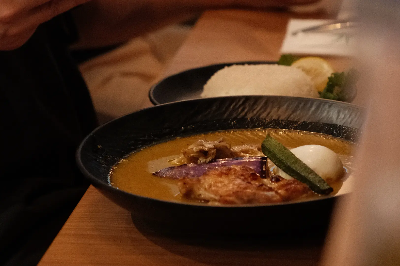 Bowl of Hokkaido soup curry by Ki-setsu in Singapore with chicken, vegetables, egg, and rice.