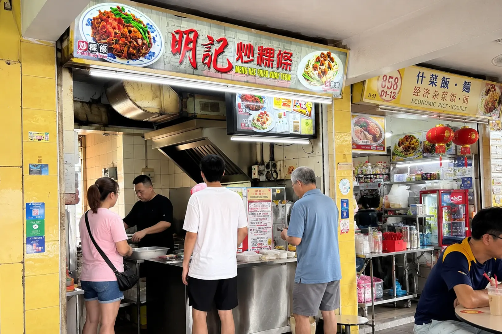 Meng Kee Fried Kway Teow stall with customers ordering at a local hawker centre.
