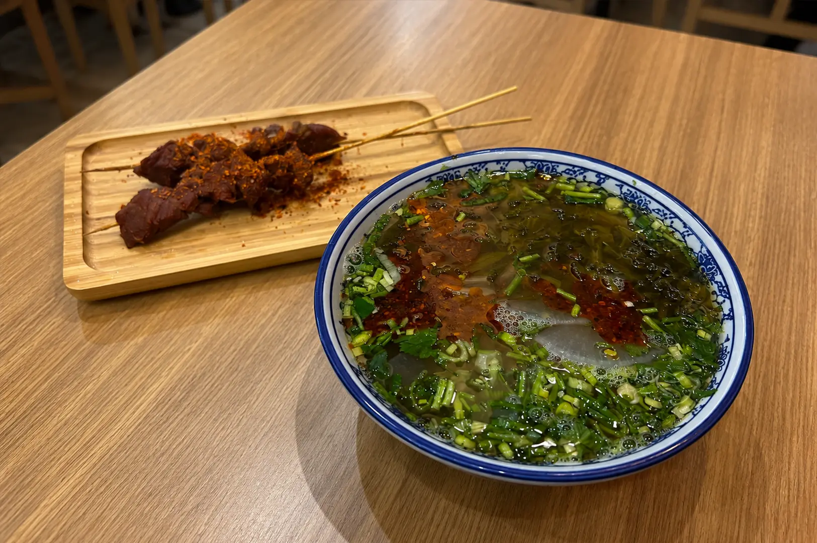 Tongue Tip Lanzhou Beef Noodles with clear beef noodle soup and spicy grilled skewers.