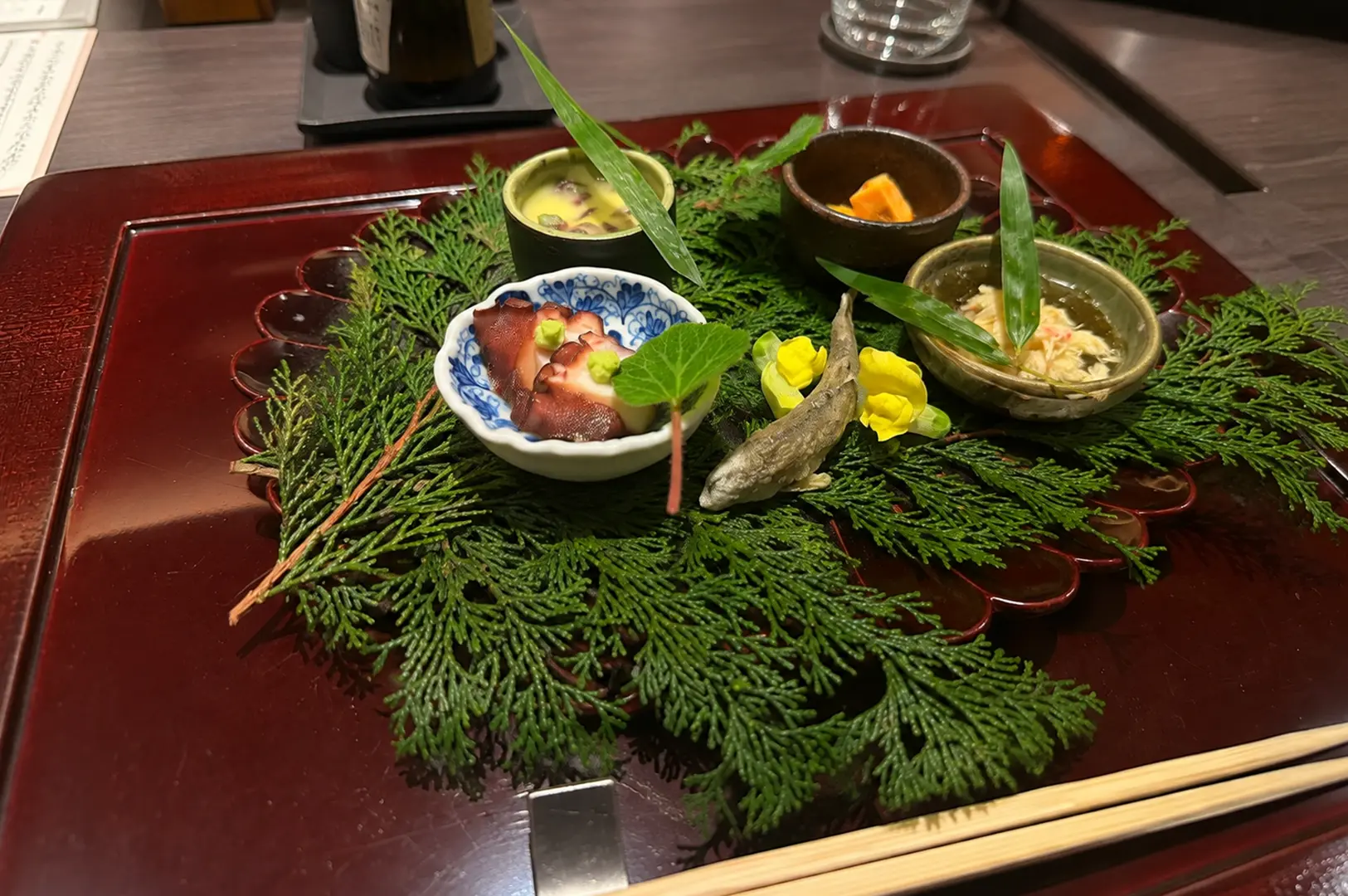 Elegant Japanese appetizer course featuring octopus, chawanmushi, and seasonal small dishes.