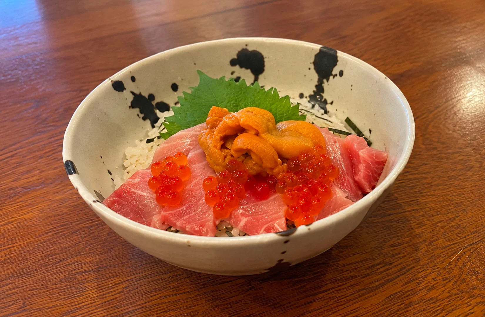 Salmon and seafood rice bowl with tempura flakes and salmon roe.