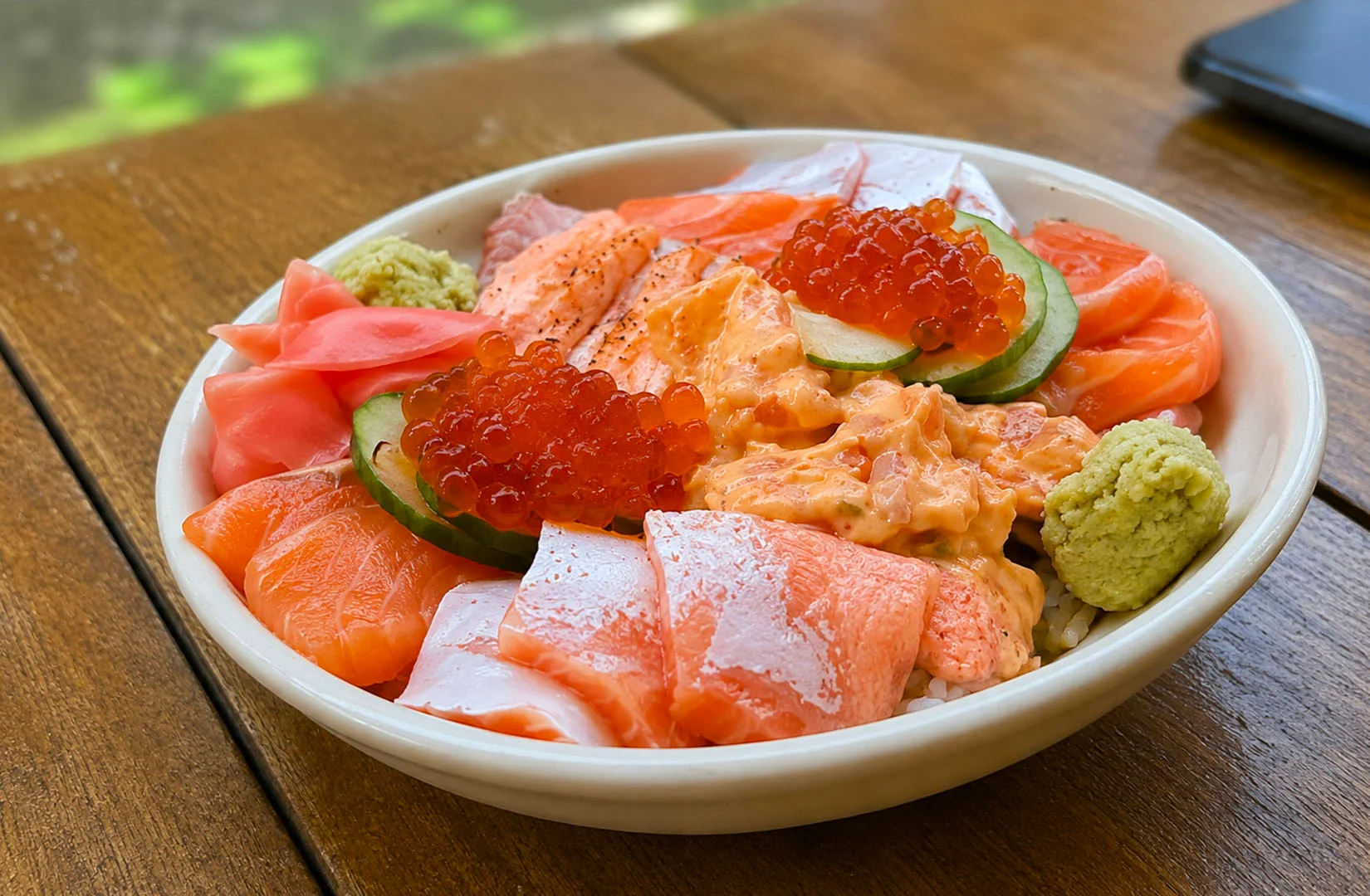 Grilled seafood rice bowl with scallops, tamago, and salmon roe.