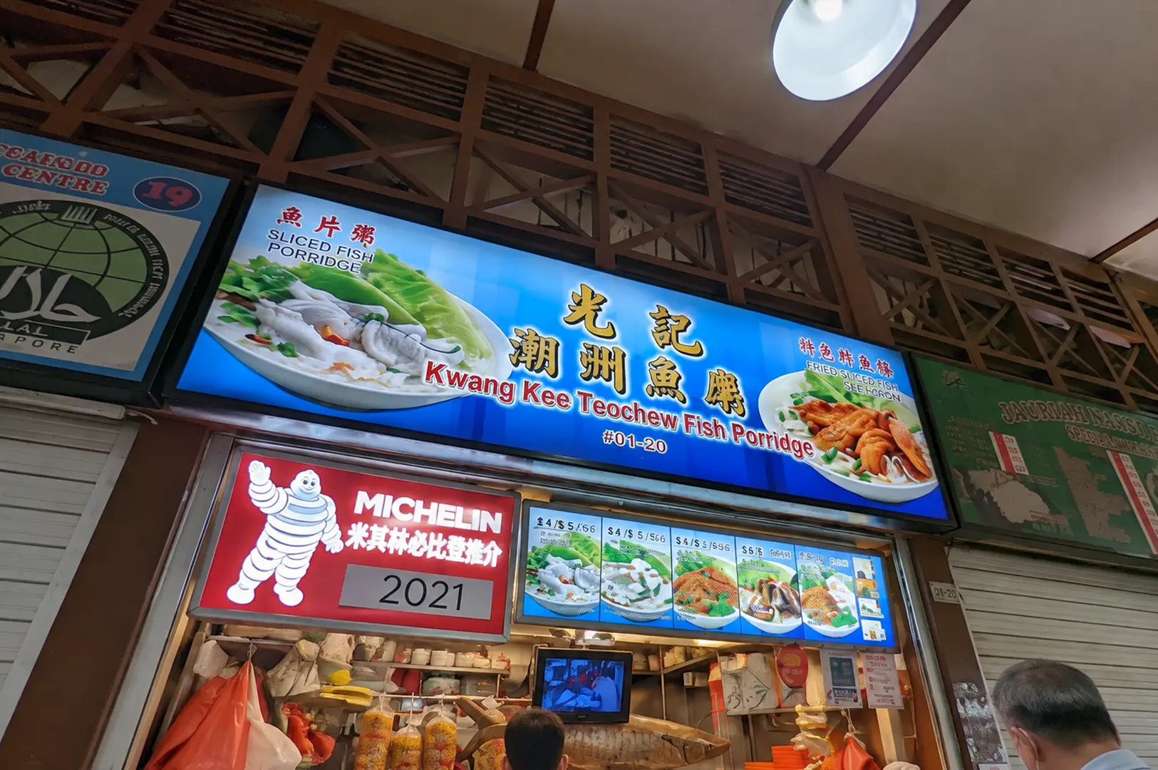 Kwang Kee Teochew Fish Porridge stall with a large blue sign and Michelin 2021 recognition.