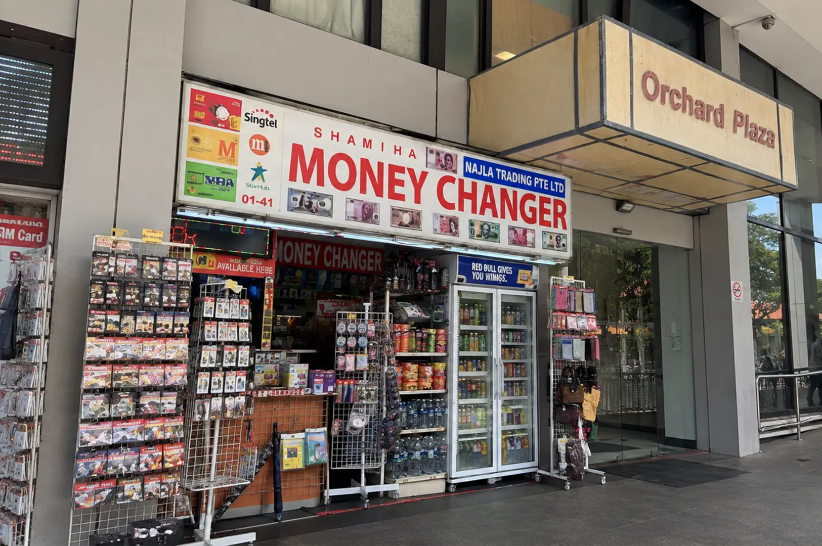Money changer and convenience shop at the entrance of Orchard Plaza in Singapore.