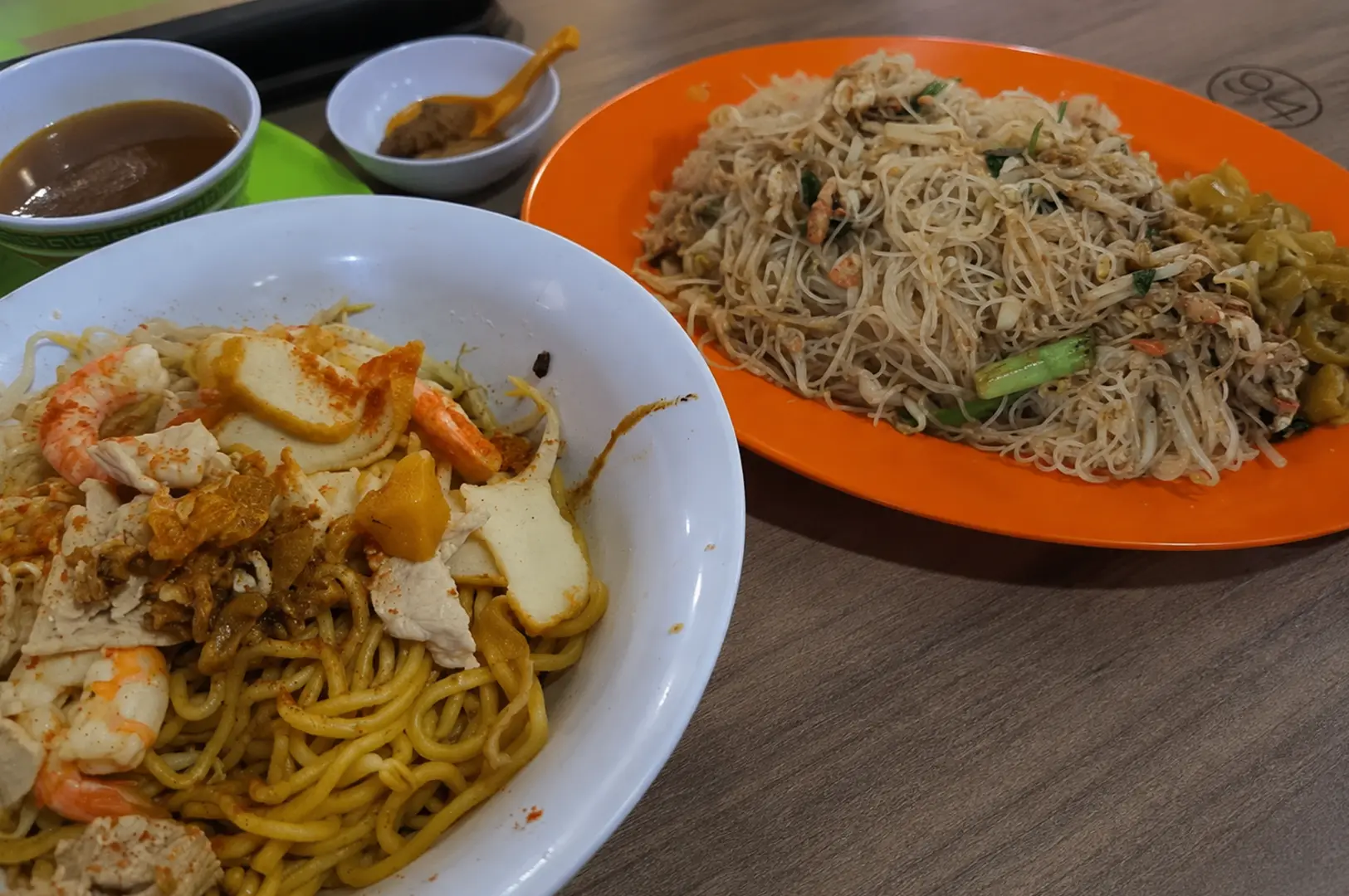 Dry curry noodles and stir-fried rice vermicelli served with soup and sambal.