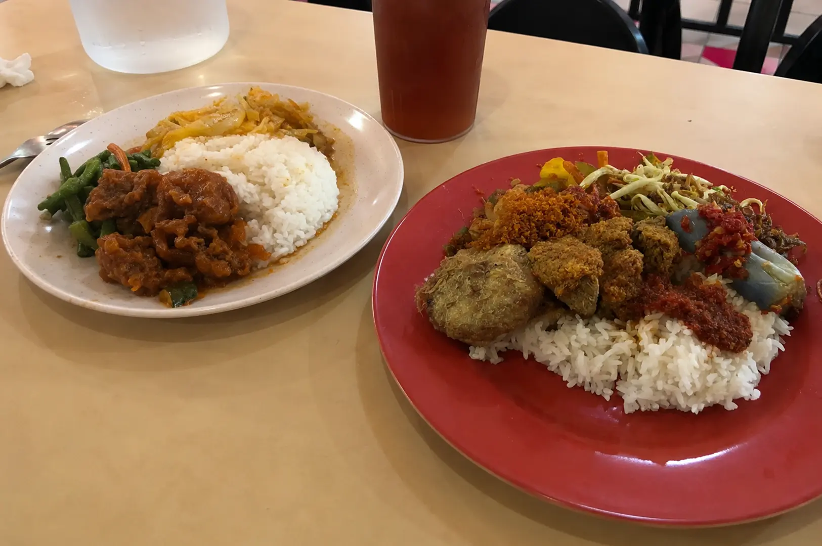 Mixed rice plates with assorted vegetables, fried items, curry, and braised meat.