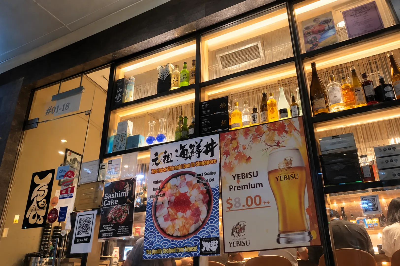 Teppei Japanese Restaurant entrance in Tanjong Pagar, Singapore, with illuminated shelves, Japanese food posters, and a warm interior.