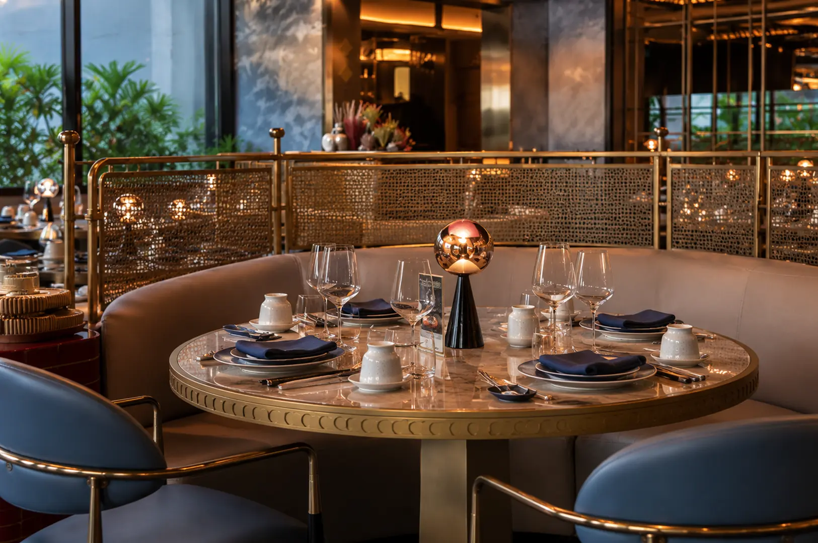 Elegant Singapore restaurant interior with a warmly lit table set for dinner.
