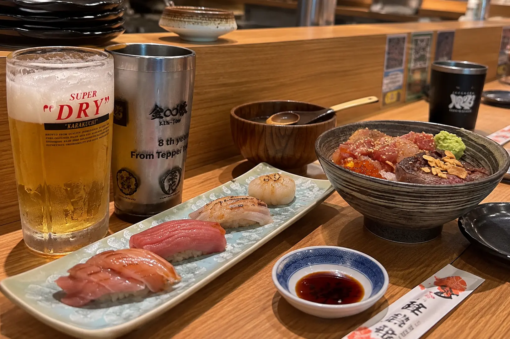 Sushi platter and bara chirashi bowl served with beer at Teppei Japanese Restaurant in Singapore.